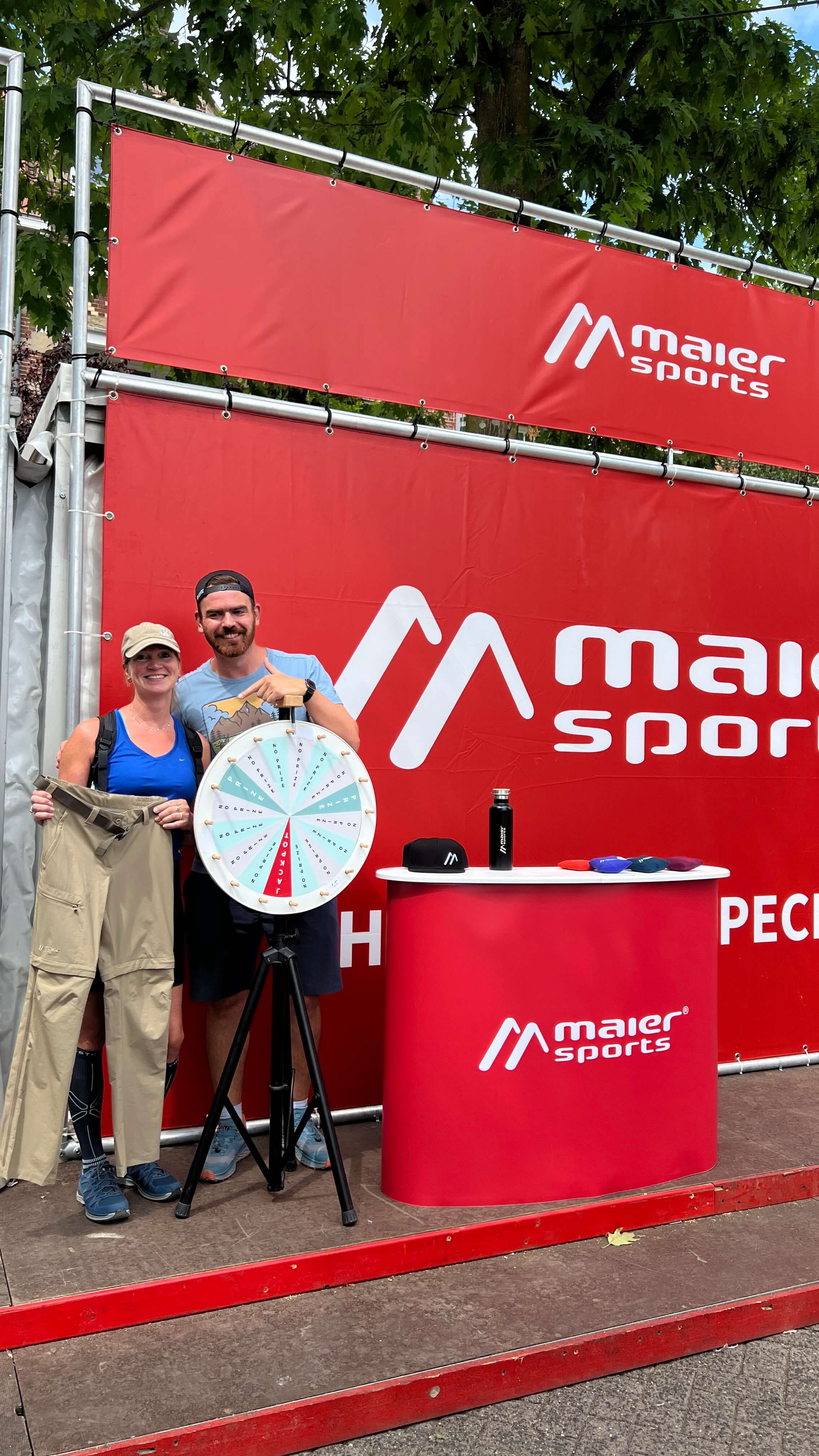 sport event, market stall, wheel of fortune, red banner, Maier Sports